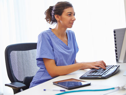 a nurse works at a computer